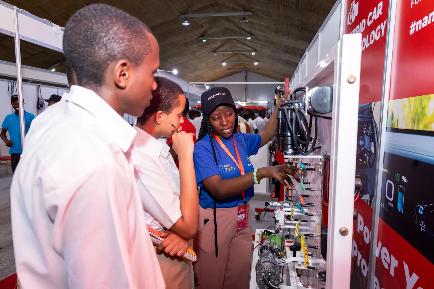 Students exploring hybrid vehicle technology at an RTB TVET expo