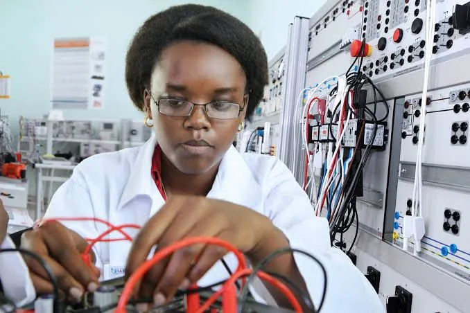 A TVET student assembling electronics in a laboratory